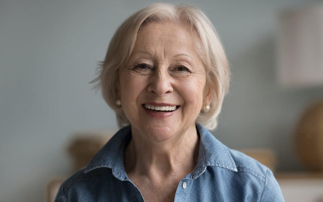 Older woman with restored smile thanks to dental implants in Salem, NH